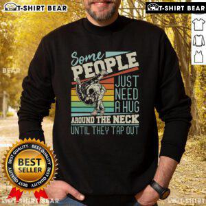 Cozy sweatshirt with 'Some People Just Need A Hug' design for Brazilian Jiu-Jitsu and MMA enthusiasts.