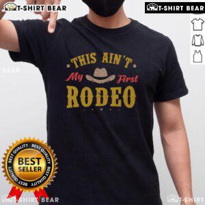 Alt Text: Top This Ain't My First Rodeo Equestrian Rodeo Cowboy T-Shirt featuring a stylish graphic design for cowboy enthusiasts.