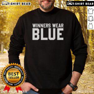 Top winners wearing blue sweatshirt celebrate their achievements at an awards ceremony, showcasing camaraderie and success.