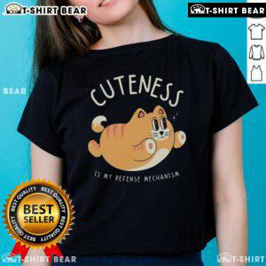 Cute cat graphic on 'Cuteness Is My Defense Mechanism' ladies tee, perfect for cat lovers and stylish casual wear.