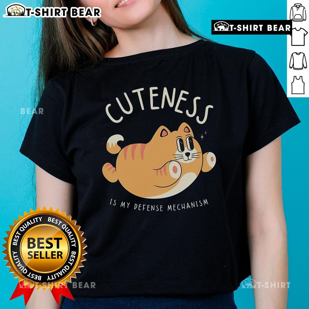 Cute cat graphic on 'Cuteness Is My Defense Mechanism' ladies tee, perfect for cat lovers and stylish casual wear.