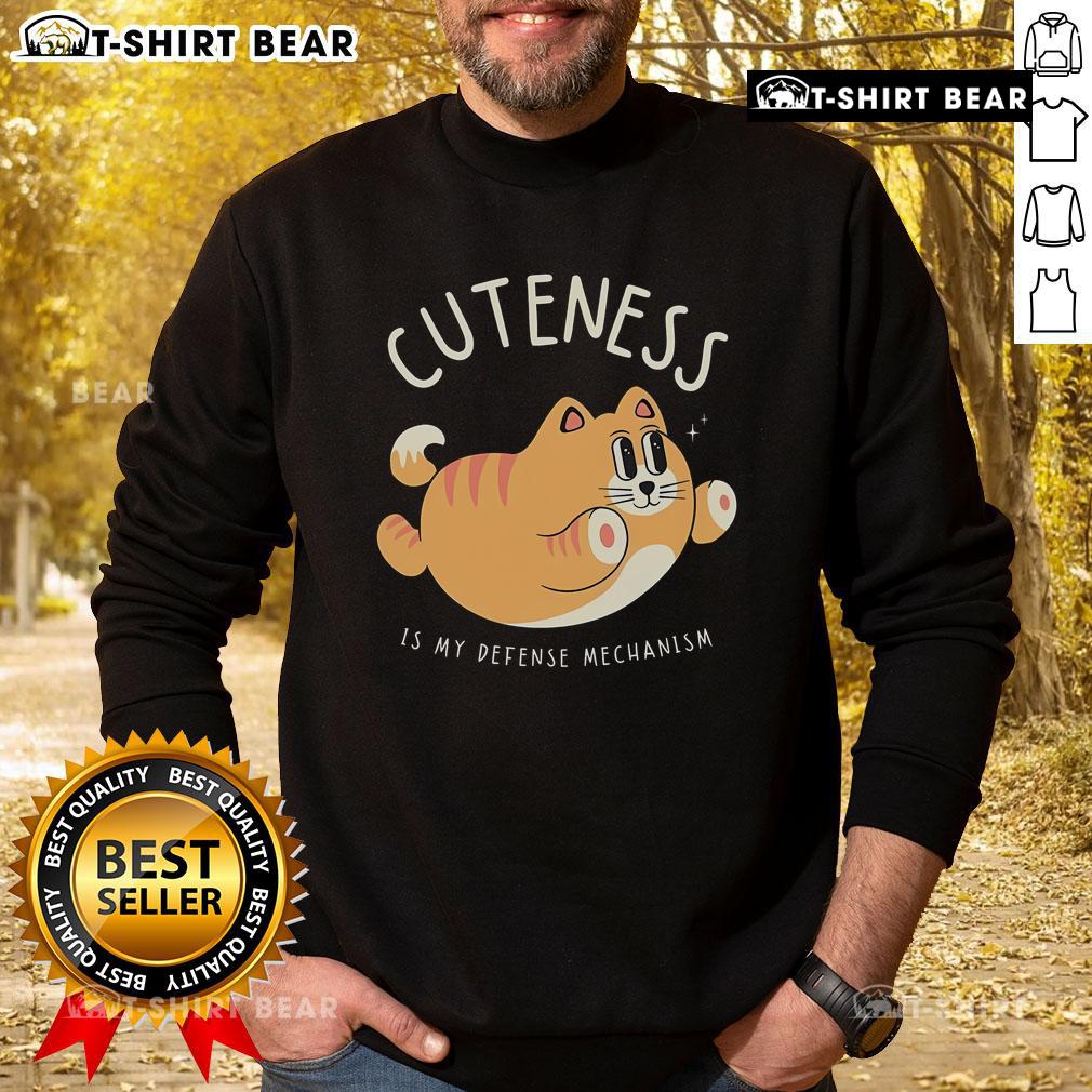 Cute Cat Cuteness Is My Defense Mechanism Sweatshirt featuring an adorable cat graphic on a cozy, stylish design.