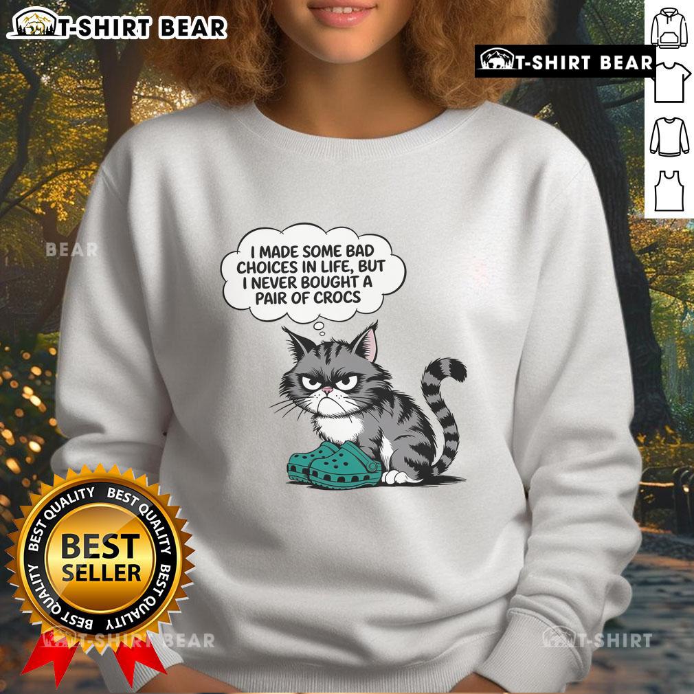 Adorable cat wearing a sweatshirt that says 'I made some bad choices in life, but I never bought a pair of Crocs.'