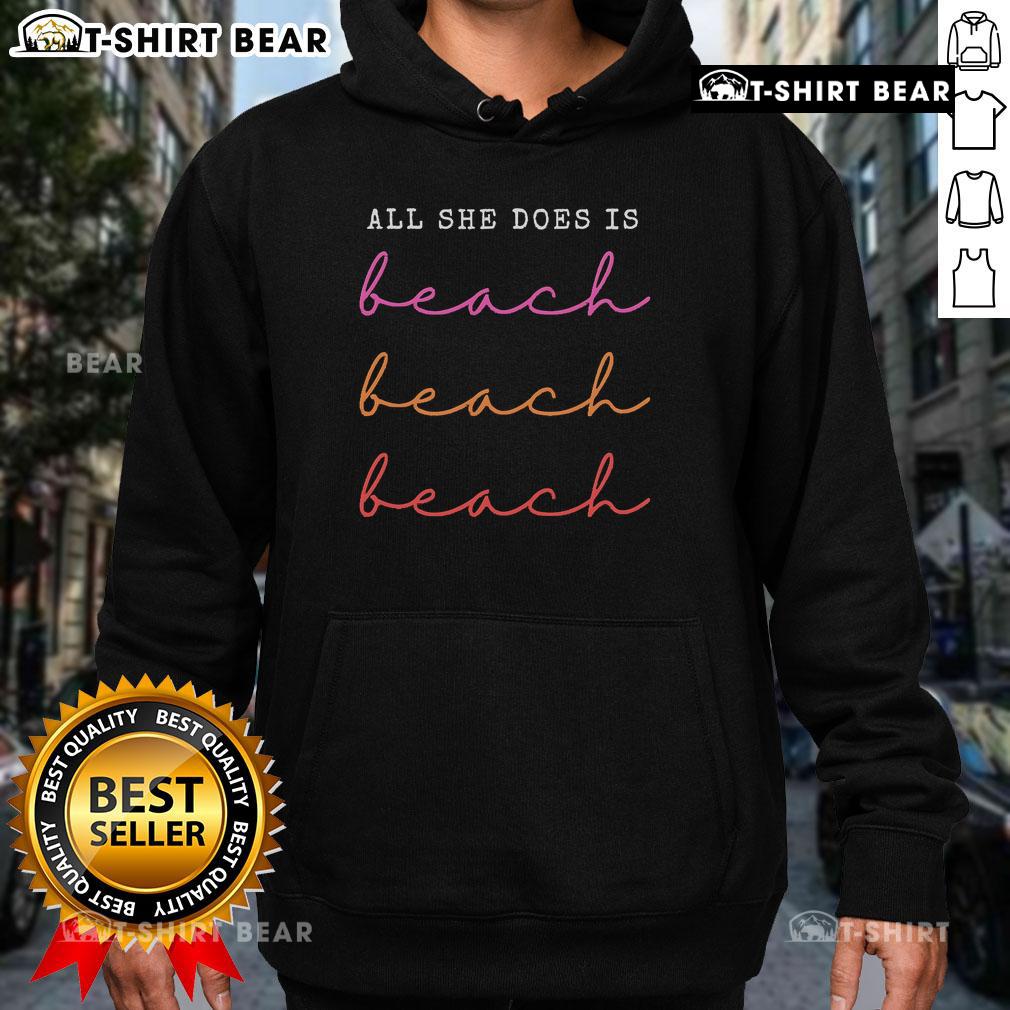 Cozy 'Top All She Does Is Beach Repeat Hoodie' in sunny beach setting, perfect for beach lovers and casual wear.