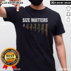 Top Size Matter Bullet Measure Up T-Shirt displayed on a hanger, showcasing its unique design and comfortable fabric.