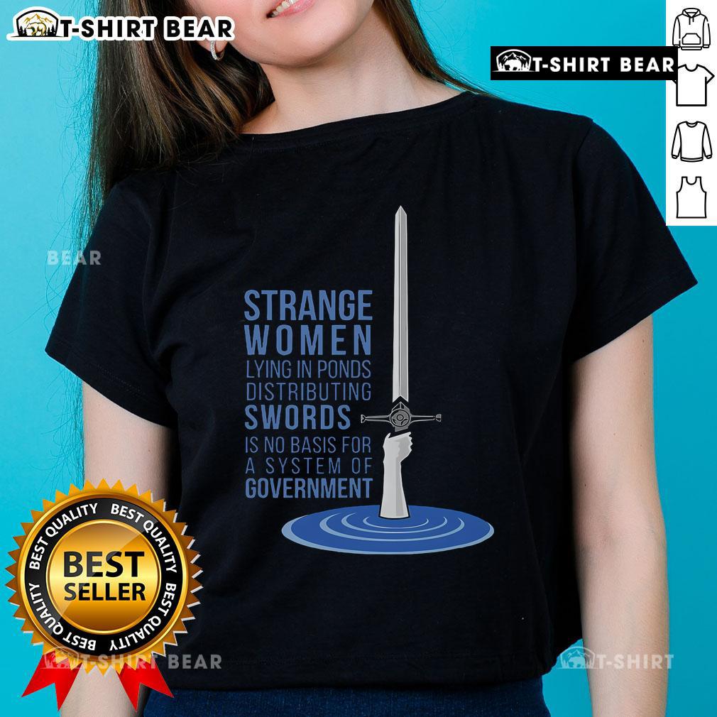 Strange women in ponds distributing swords, showcasing the 'Ladies Tee' design, humorously critiquing government systems.