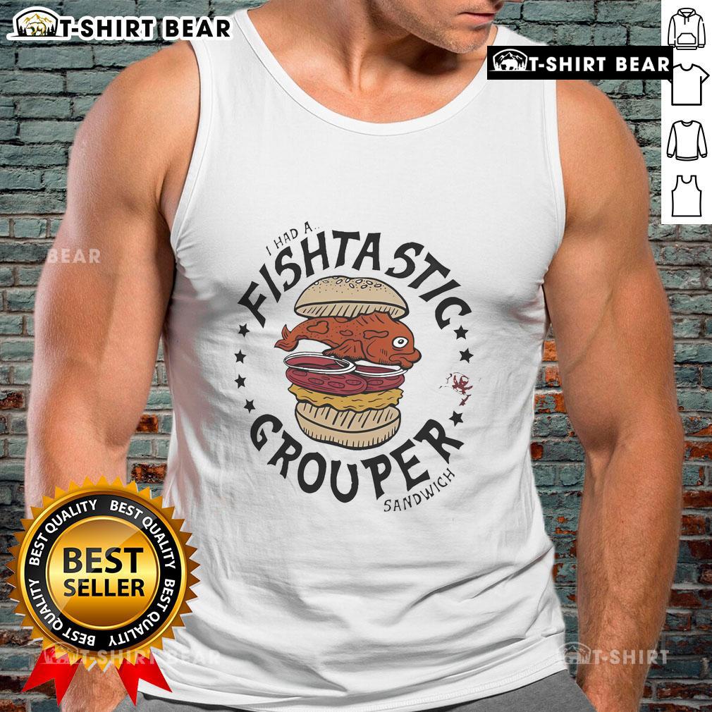 Fan wearing a 'Flavortown' tank top enjoying a grouper sandwich at a Tampa Bay Buccaneers game.