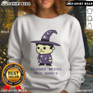 Cozy Top Wizard Needs Hugs Badly Sweatshirt featuring a whimsical design, perfect for magic lovers and comfort seekers.