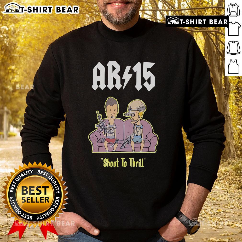 Official Beavis and Butthead AR-15 Shoot to Thrill sweatshirt on a sofa, showcasing fun retro graphic design.