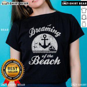 Top featuring 'Dreaming of the Beach' design, perfect for summer happiness, water life, and sand love. Ideal ladies tee.
