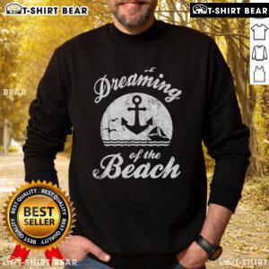 Cozy sweatshirt featuring 'Dreaming of the Beach' design, perfect for summer happiness and beach lovers.