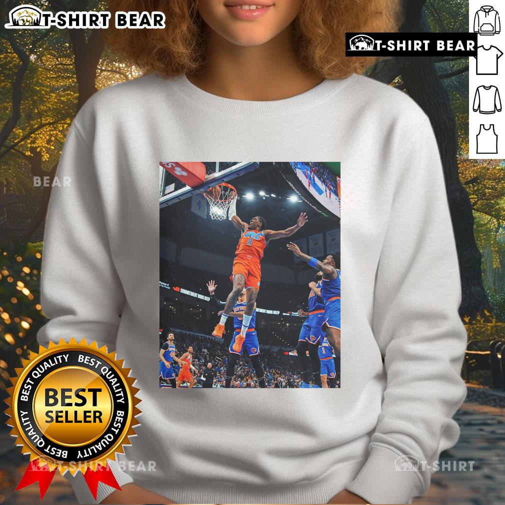 Alt Text: Jalen Williams soaring for a score in a black Oklahoma sweatshirt, showcasing athleticism and team spirit.
