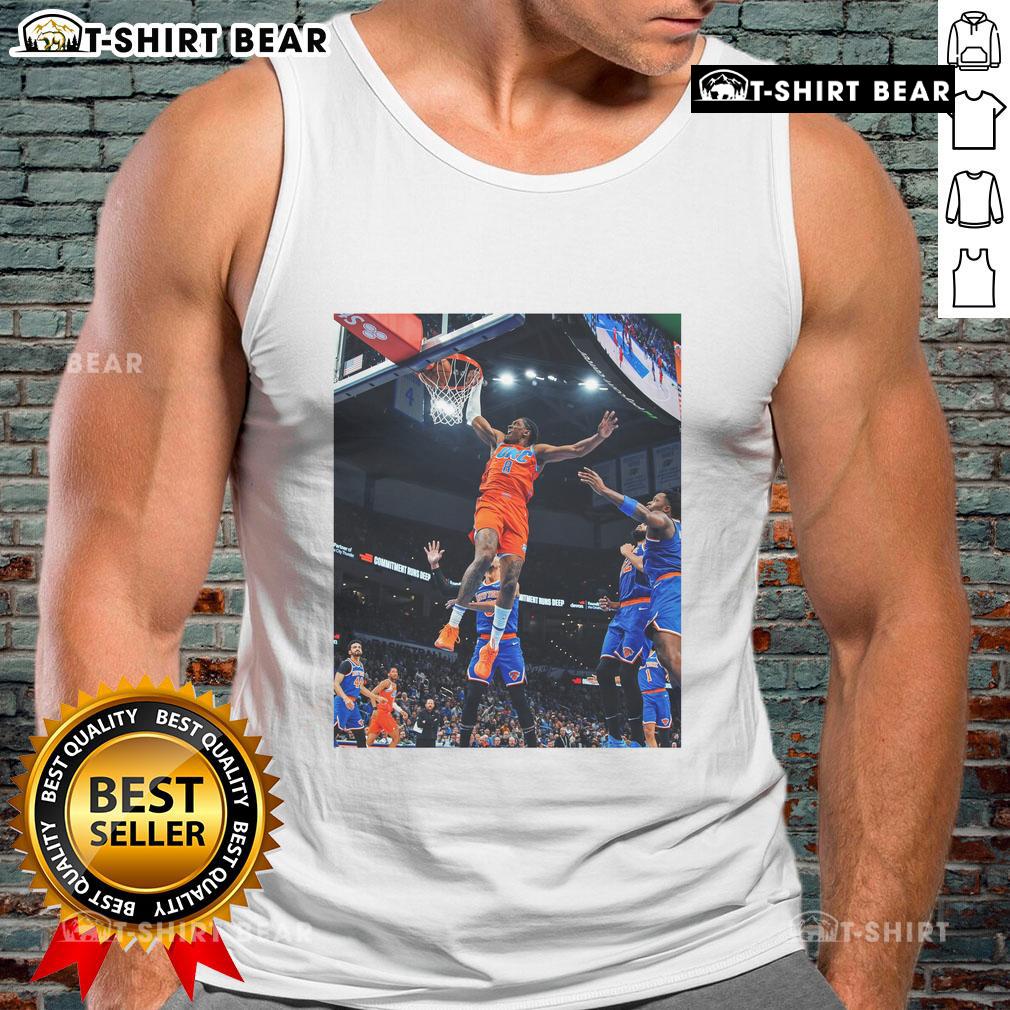 Jalen Williams soaring for a score in a black tank top during an Oklahoma game, showcasing athleticism and style.