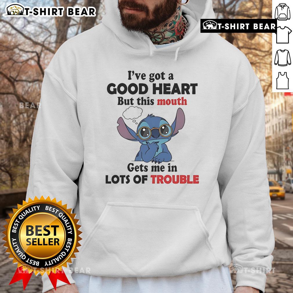 Alt Text: Person wearing 'I've Got A Good Heart But This Mouth Gets Me In Lots Of Trouble' hoodie, showcasing stylish streetwear.