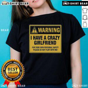 Premium warning tee shirt: 'I Have A Crazy Girlfriend' message for personal safety, perfect for humorous fashion.