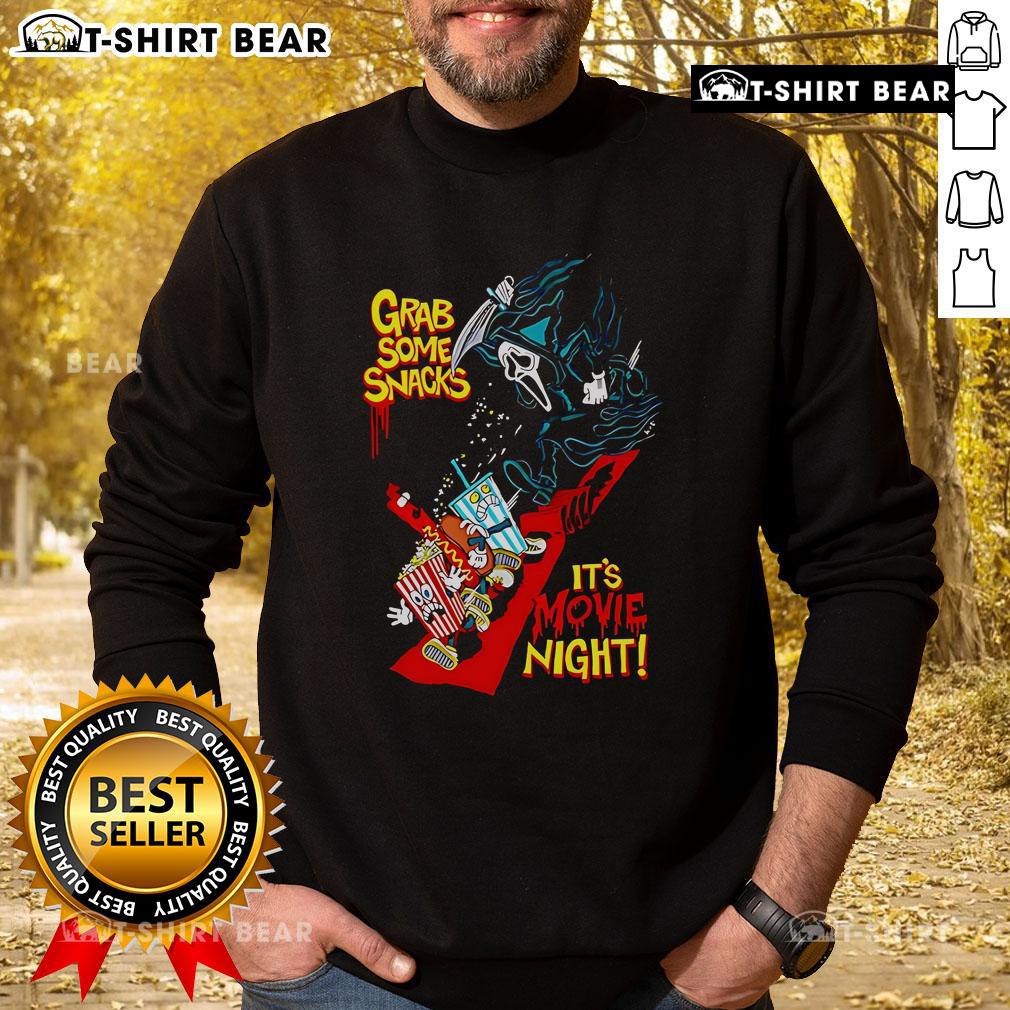 Cozy 'Top Grab Some Snacks It's Movie Night' sweatshirt featuring fun typography, perfect for comfortable movie nights.