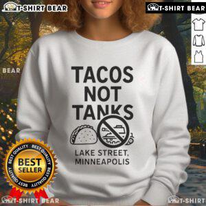 Cozy sweatshirt featuring Top Tacos Not Tanks design, perfect for Minneapolis street style enthusiasts.