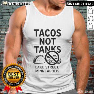 Top Tacos Not Tanks tank top displayed on Lake Street in Minneapolis, featuring vibrant taco-themed design.