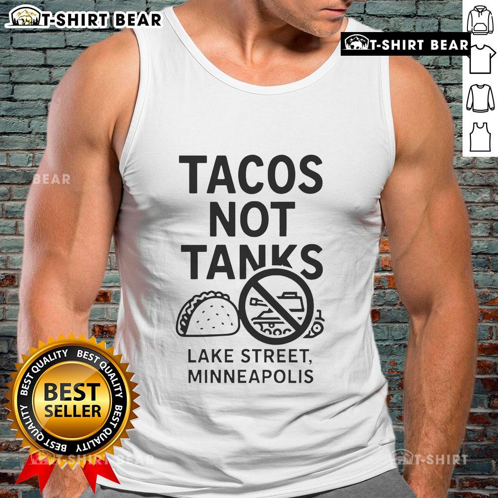 Top Tacos Not Tanks tank top displayed on Lake Street in Minneapolis, featuring vibrant taco-themed design.