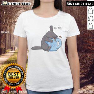 Cute cat playfully drowning in a coffee cup, featured on a humorous I'm Ok ladies tee design. Perfect for cat lovers!