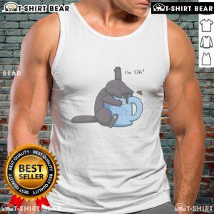 Cute cat playfully submerged in a coffee cup, wearing an 'I'm OK' tank top, perfect for coffee lovers and cat enthusiasts.