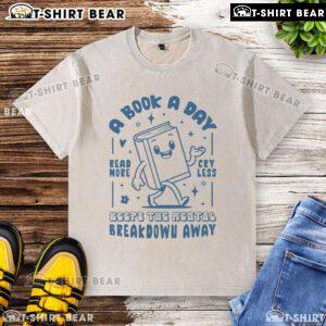 White washed t-shirt with 'A Book A Day Keeps The Mental Breakdown Away' printed in stylish font for book lovers.