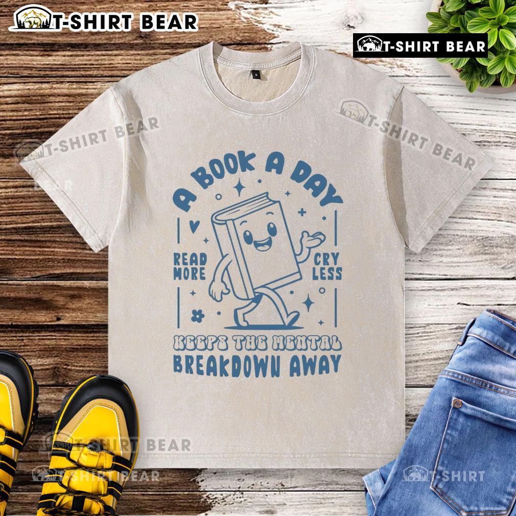 White washed t-shirt with 'A Book A Day Keeps The Mental Breakdown Away' printed in stylish font for book lovers.