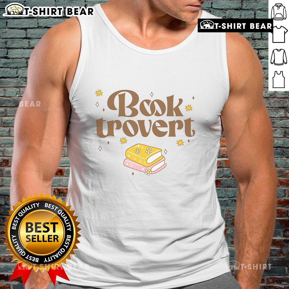Funny book lover wearing a 'Pretty Booktrovert' tank top while reading a book in a cozy setting.
