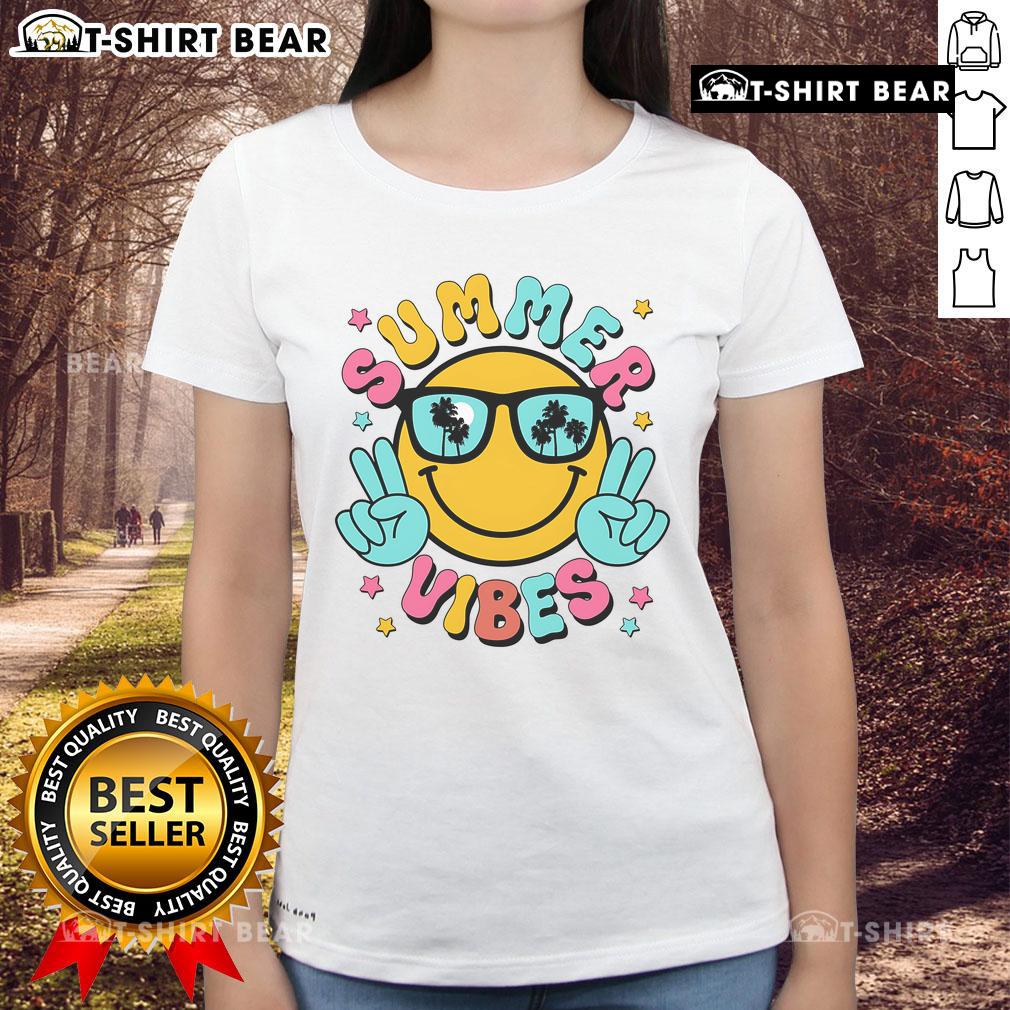 Pretty summer vibes with a tropical sunset beach scene featuring women in stylish tees, perfect for vacation wear.