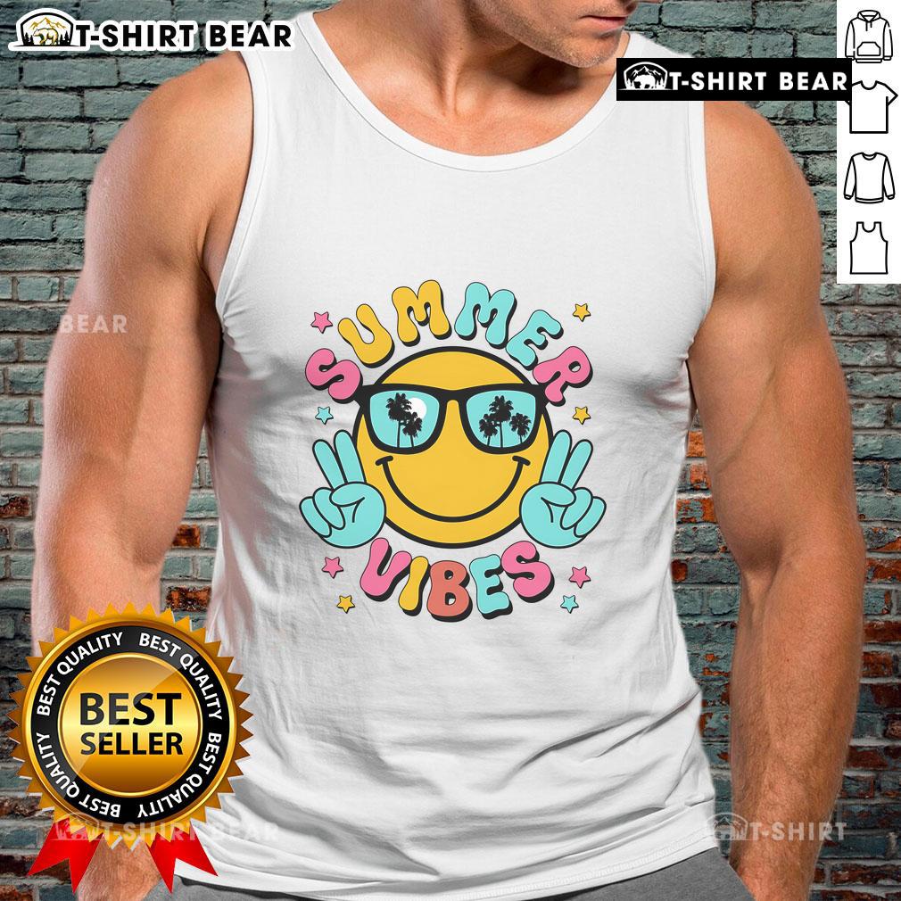 Pretty summer vibes with a tropical sunset beach vacation tank top against a vibrant sunset backdrop.
