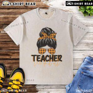 Pretty teacher with a messy bun wearing a washed T-shirt, showcasing a casual and stylish classroom vibe.