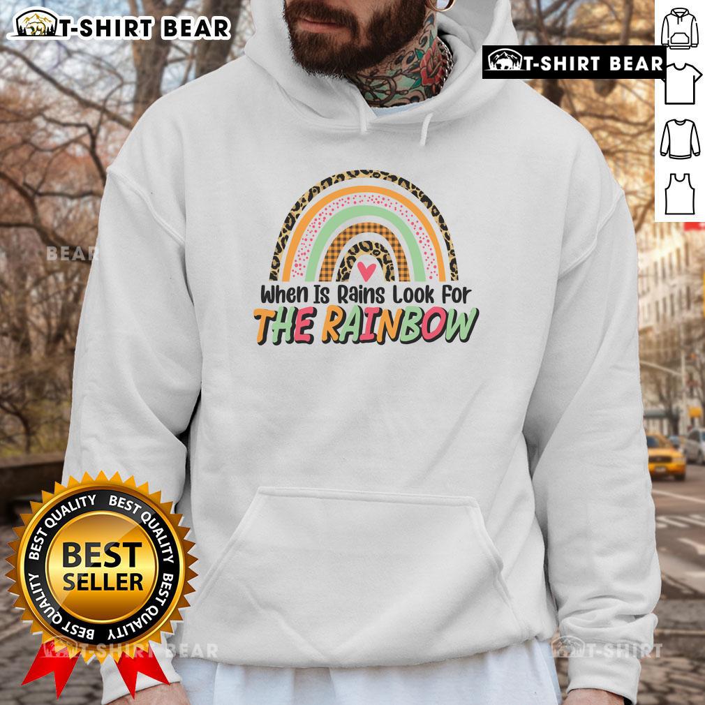 Colorful 'Pretty When It Rains Look For The Rainbow' hoodie displayed against a vibrant rainbow backdrop, perfect for rainy days.