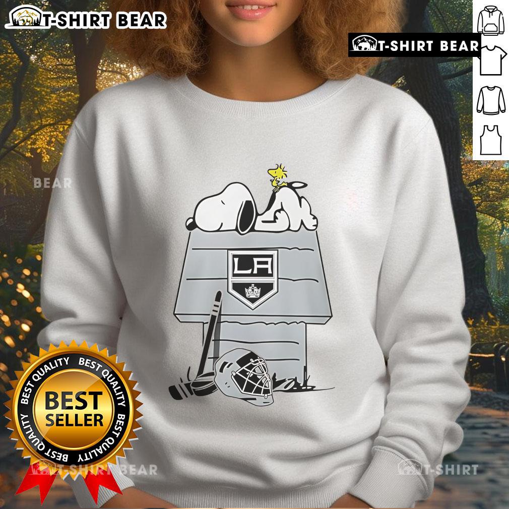 Cozy Los Angeles Kings NHL hockey sweatshirt featuring Snoopy and Woodstock designs, perfect for fans and casual wear.