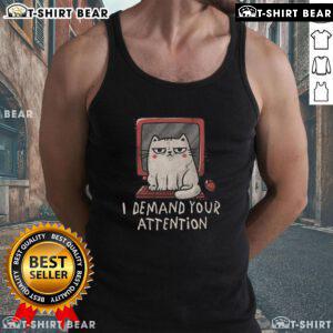 Alt Text: Cute cat lounging on a keyboard, showcasing the 'I Demand Your Attention' tank top in a cozy home setting.