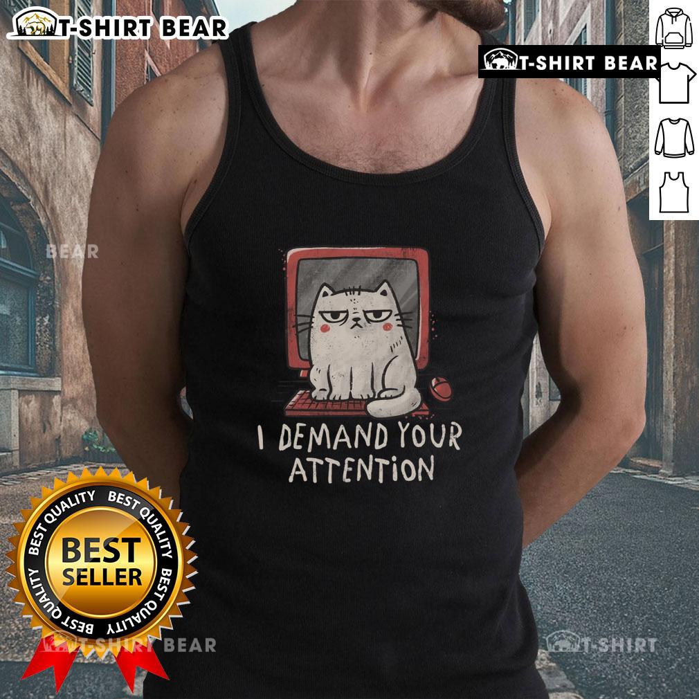 Alt Text: Cute cat lounging on a keyboard, showcasing the 'I Demand Your Attention' tank top in a cozy home setting.
