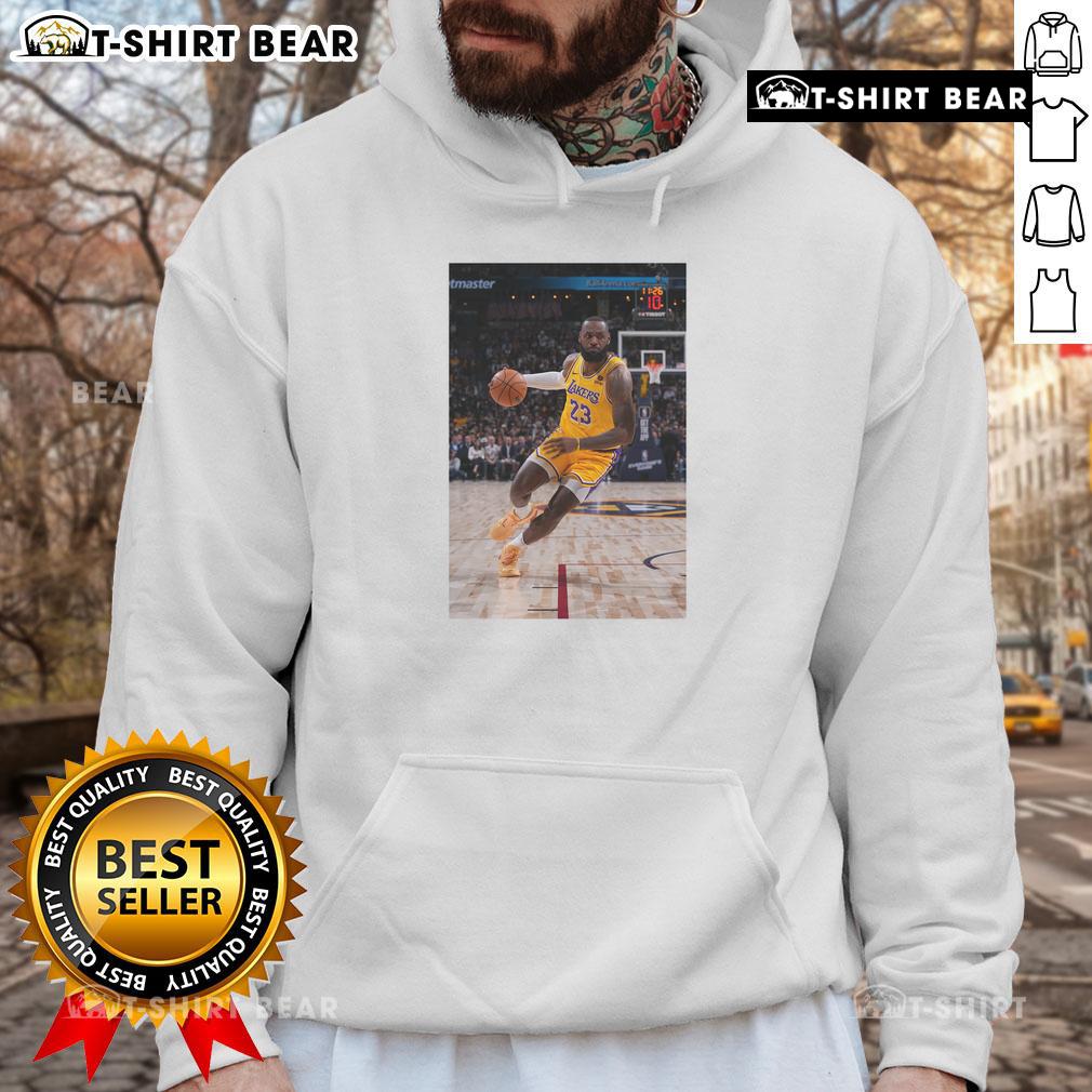 Alt Text: LeBron James in a stylish Los Angeles Lakers hoodie, showcasing his iconic Number 23 pose as a basketball superstar.