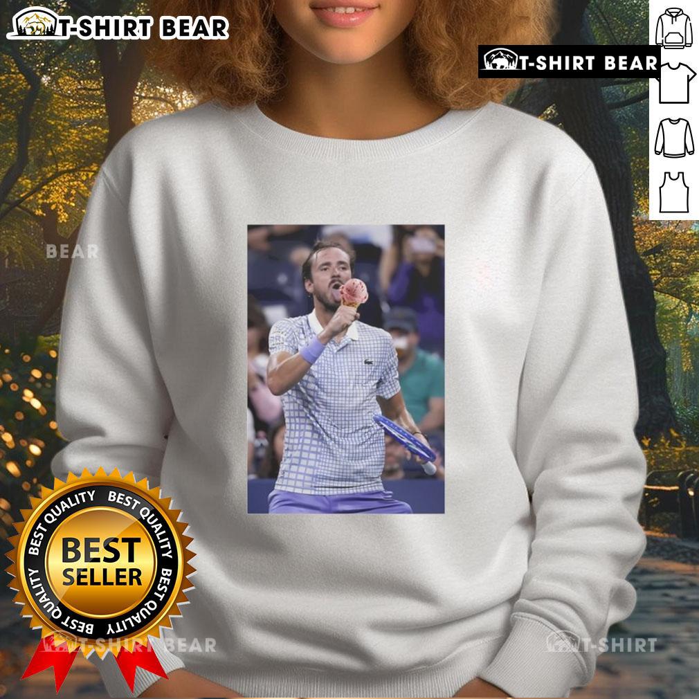 Daniil Medvedev enjoying ice cream on the field at the US Open, wearing a stylish sweatshirt, showcasing a fun moment.