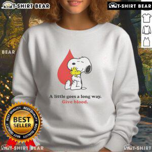 Nice A Little Goes A Long Way Give Blood Snoopy Sweatshirt featuring Snoopy promoting blood donation in a cozy design.