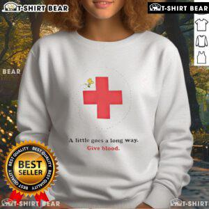 American Red Cross Woodstock sweatshirt promoting blood donation with the slogan 'A Little Goes a Long Way'.