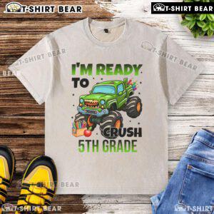 Child wearing a washed t-shirt with a monster truck design, ready to crush 5th grade challenges.