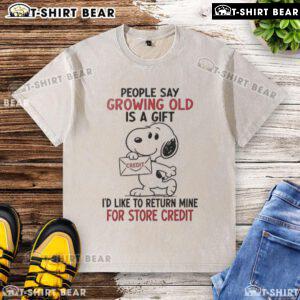 Original Snoopy Growing Old Is A Gift washed t-shirt featuring Snoopy and a humorous quote about aging.