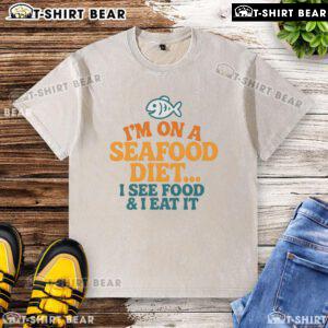 Funny washed t-shirt with the quote 'I'm on a seafood diet...I see food, I eat it' perfect for seafood lovers.