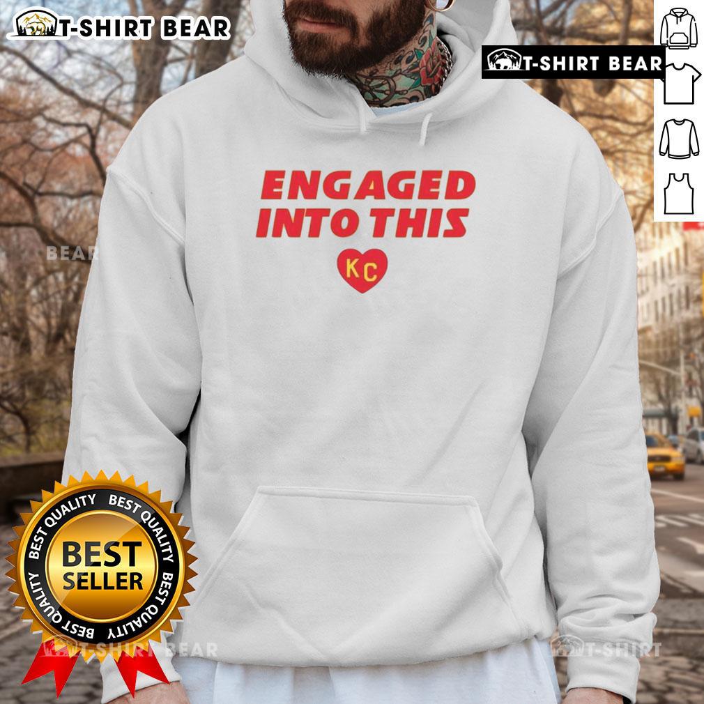 Fan wearing a KC Chiefs hoodie, showcasing team spirit and engagement at a game, perfect for NFL enthusiasts.