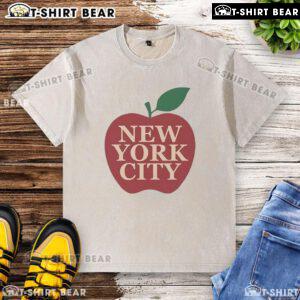 Eric Stonestreet wearing a stylish New York City apple washed t-shirt in a vibrant urban setting.