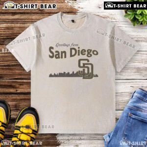 Alt Text: Top Greetings From San Diego Padres Skyline Washed T-Shirt featuring vibrant city skyline and Padres logo.