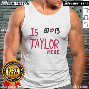 Taylor Swift wearing a Travis Kelce Chiefs 87 love tank top, showcasing her support for the NFL star.