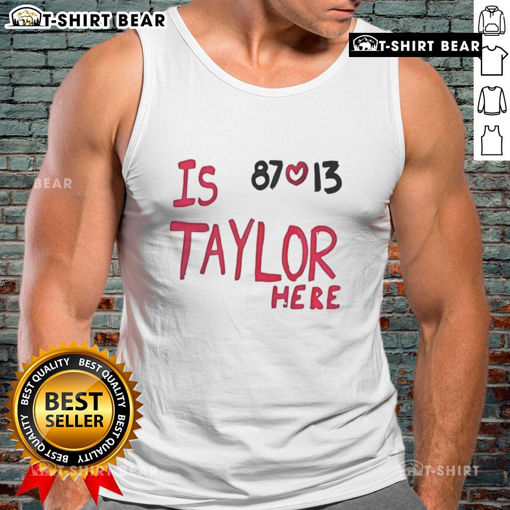 Taylor Swift wearing a Travis Kelce Chiefs 87 love tank top, showcasing her support for the NFL star.