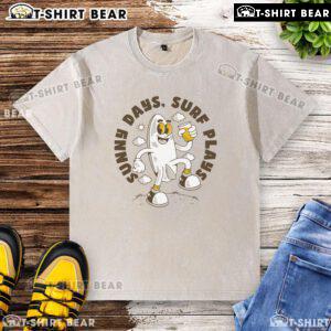 Top Sunny Days Surf Plays retro surfboard cartoon design on a washed t-shirt, perfect for beach lovers and surf enthusiasts.