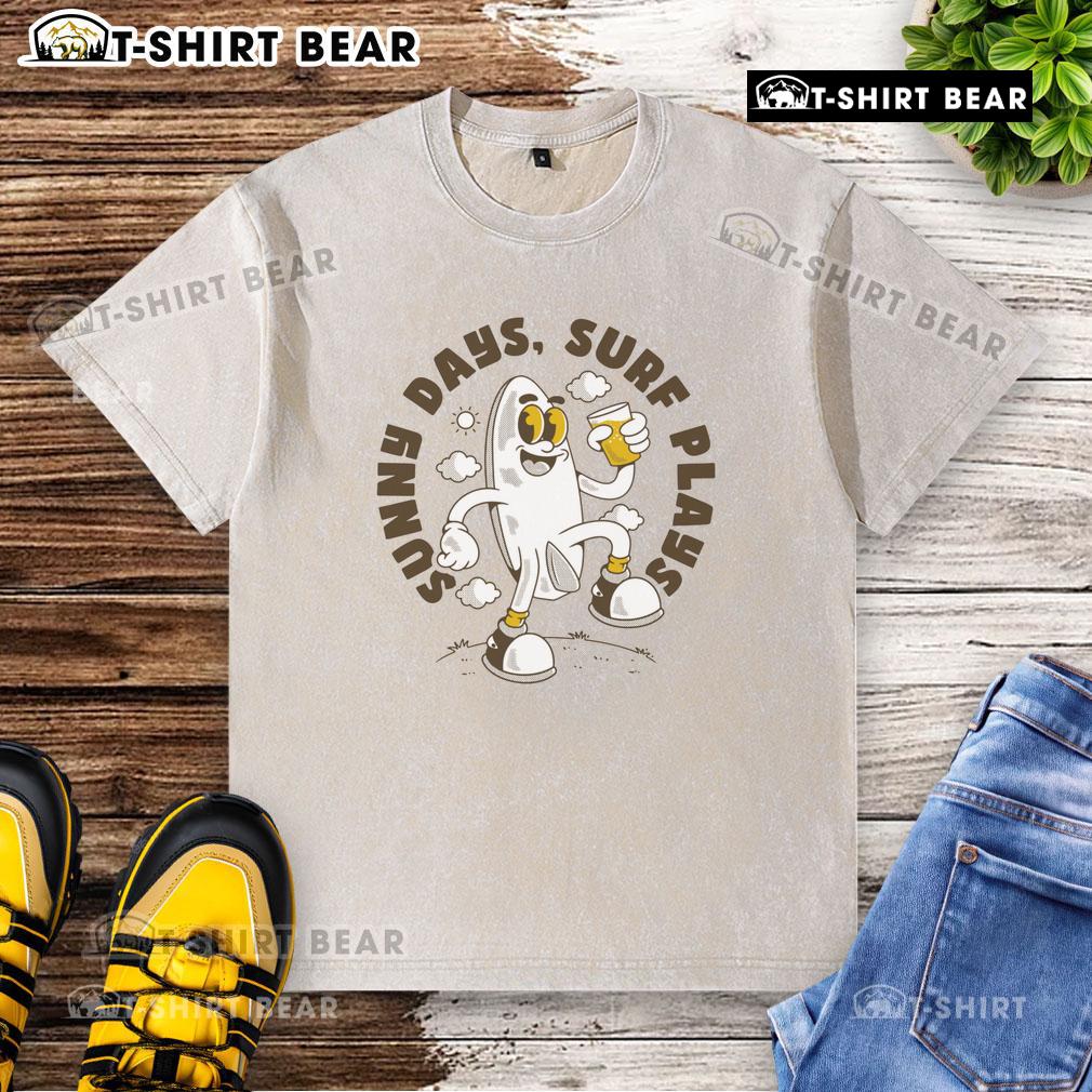 Top Sunny Days Surf Plays retro surfboard cartoon design on a washed t-shirt, perfect for beach lovers and surf enthusiasts.