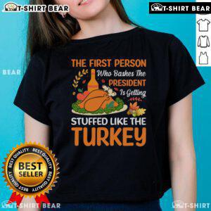Funny 'Top-The-First-Person-Who-Bashes-The-President' turkey-themed ladies tee, perfect for holiday humor.